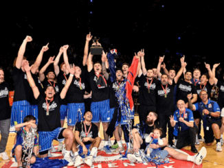 Wellington Saints players and staff celebrating their NBL championship win on court at TSB Arena.