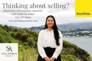 A real estate promotional image featuring Sasa Aperila of Ray White Realty standing outdoors in front of a scenic coastal view with hills and homes in the background. The text reads: “Thinking about selling? Would like a free property appraisal? Call/Email me today! 021 297 0043 sasa.aperila@raywhite.com.” Logos for Ray White and Sasa Aperila Realty appear in the corners.
