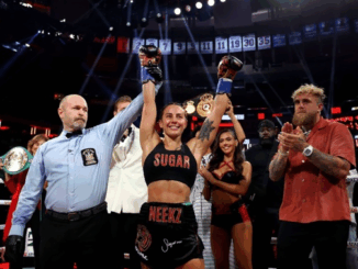 Cherneka Johnson raises her arms in victory after winning the undisputed bantamweight world title at Madison Square Garden.