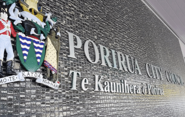 Porirua City Council building wall with crest and bilingual signage.