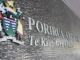 Porirua City Council building wall with crest and bilingual signage.