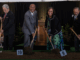 Group of dignitaries turning soil with shovels at the Wellington New Zealand Temple groundbreaking ceremony.