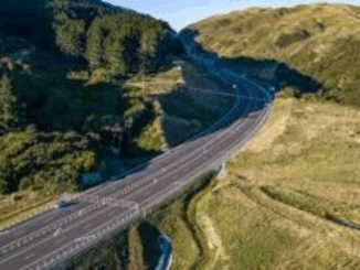 Aerial view of Transmission Gully motorway winding through hills and forest in the Wellington region.