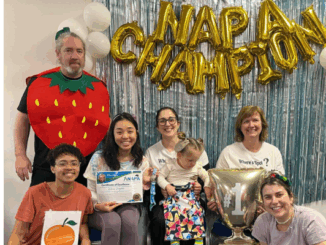 Group of therapists and a child posing under “NAPA Champion” balloons at a paediatric therapy event in Porirua, New Zealand