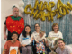 Group of therapists and a child posing under “NAPA Champion” balloons at a paediatric therapy event in Porirua, New Zealand