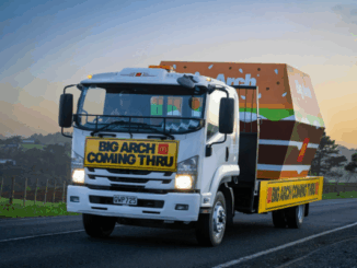 McDonald’s Big Arch promotional truck driving on a rural New Zealand road, featuring a large burger-shaped box and a sign reading "BIG ARCH COMING THRU" on the front.