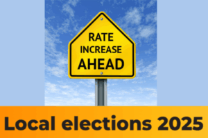 Yellow road sign reading “Rate Increase Ahead” under a blue sky, symbolising rising council rates ahead of the 2025 local elections.