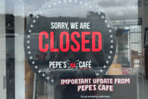 Closed sign displayed on the door of Pepe’s Cafe in Porirua.