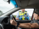 Police officer conducting a roadside saliva drug test during a traffic stop in Porirua.