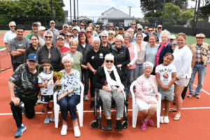 Members and supporters of Titahi Bay Tennis Club gather on the courts during centenary celebrations marking 100 years since the club was founded.