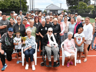 Members and supporters of Titahi Bay Tennis Club gather on the courts during centenary celebrations marking 100 years since the club was founded.