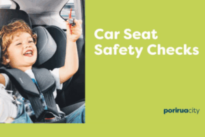 A smiling young child sits in a properly fitted car seat inside a vehicle, holding a small toy, alongside text promoting car seat safety checks.