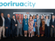 Porirua Mayor Anita Baker and city councillors pose for an official group photo in front of Porirua City branding.