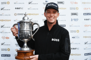 Golfer Daniel Hillier smiles while holding the New Zealand Open trophy after winning the tournament at Millbrook Resort in Arrowtown.