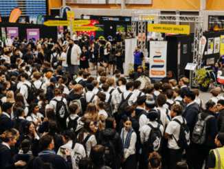 Students gather around exhibition stands during the Careers Expo 2025 at Te Rauparaha Arena in Porirua.