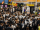 Students gather around exhibition stands during the Careers Expo 2025 at Te Rauparaha Arena in Porirua.