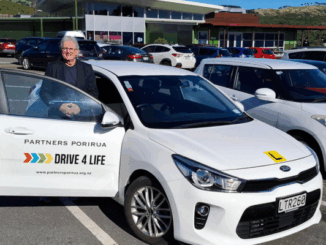Porirua City Councillor Ross Leggett standing beside a Drive 4 Life training car
