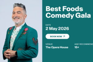 A promotional graphic shows comedian Dai Henwood in a green embroidered suit beside text advertising the Best Foods Comedy Gala on May 2, 2026 at The Opera House.