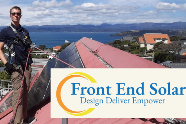 Technician installing solar panels on a residential rooftop overlooking the coast, with Front End Solar branding and the tagline “Design Deliver Empower.”