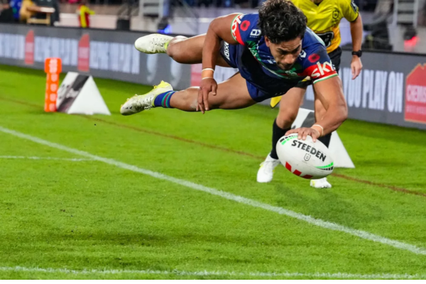 Alofiana Khan-Pereira dives low to ground the ball near the try line for the Warriors during their match against the Dolphins in Wellington.