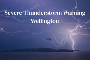 Lightning forks across a dark sky over Wellington’s coastline, with overlaid text reading “Severe Thunderstorm Warning Wellington”.