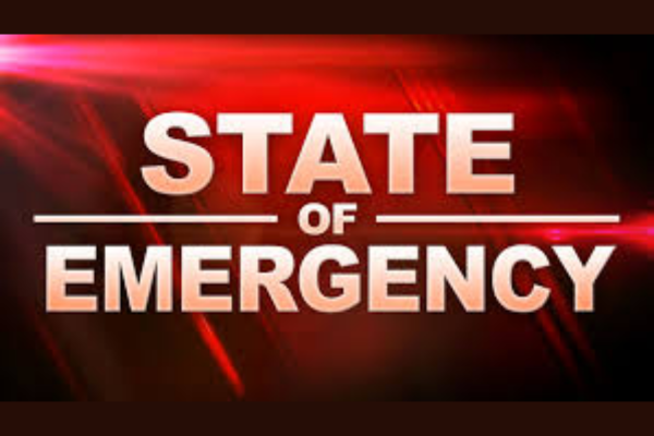 Red emergency-style graphic with bold white text reading “State of Emergency” against a dark red background with light streak effects.