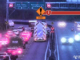 Traffic is backed up on a motorway as emergency services respond to a crash, with warning signage visible above the road.