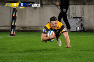 Hurricanes player dives over the try line with the ball during a Super Rugby Pacific match against the Highlanders.