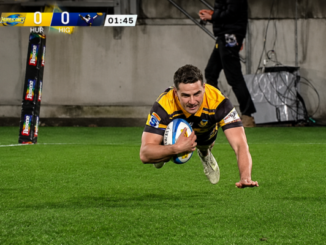 Hurricanes player dives over the try line with the ball during a Super Rugby Pacific match against the Highlanders.