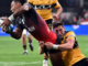 A Hurricanes player dives toward the try line while being tackled by a Crusaders defender during their Super Rugby Pacific match at One New Zealand Stadium in Christchurch.