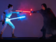 Alt text: Two LEGO-built Star Wars characters face off with glowing lightsabers, one blue and one red, posed mid-duel against a dark, smoky background.
