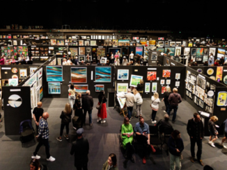 Visitors walk through rows of artwork displays at the NZ Art Show inside TSB Arena and Shed 6 in Wellington.