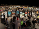 Visitors walk through rows of artwork displays at the NZ Art Show inside TSB Arena and Shed 6 in Wellington.