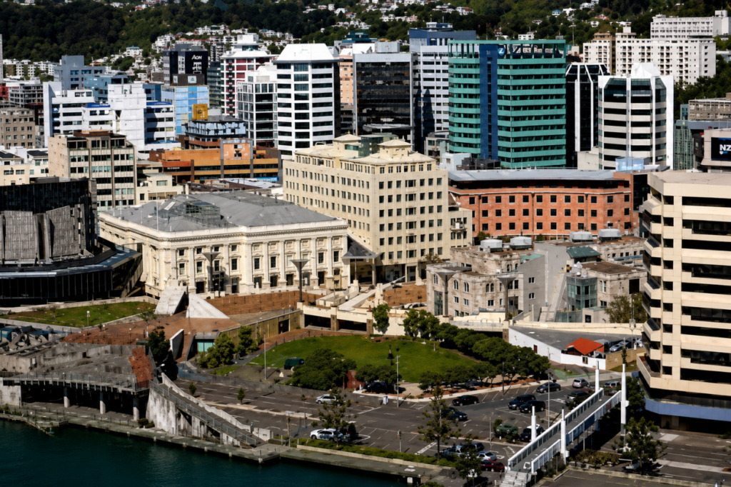Aerial view of central Wellington, showing the waterfront, civic buildings, office towers and surrounding hillside.