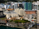 Aerial view of central Wellington, showing the waterfront, civic buildings, office towers and surrounding hillside.