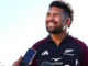 Ardie Savea smiles while speaking to reporters in All Blacks training gear.