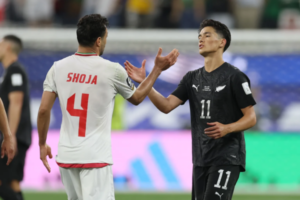 New Zealand’s Eli Just shakes hands with Iran’s Shoja Khalilzadeh during their 2-2 World Cup draw in Los Angeles.