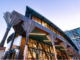 Te Matapihi ki te Ao Nui, Wellington’s central library, lit at dusk with its distinctive nikau palm columns visible outside.