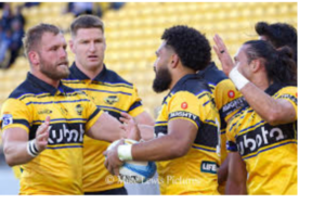 Alt text: Hurricanes players celebrate during a Super Rugby Pacific match in Wellington.