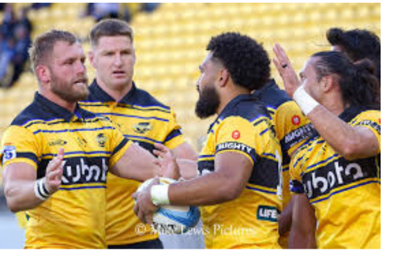 Alt text: Hurricanes players celebrate during a Super Rugby Pacific match in Wellington.
