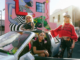 Dreamgirls Art Collective members pose beside a car in front of a colourful Matariki-inspired mural in central Wellington.