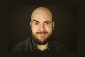 Portrait of newly appointed New Zealand Fringe Festival director Luke Eisemann against a dark background.