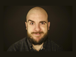 Portrait of newly appointed New Zealand Fringe Festival director Luke Eisemann against a dark background.