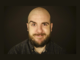 Portrait of newly appointed New Zealand Fringe Festival director Luke Eisemann against a dark background.