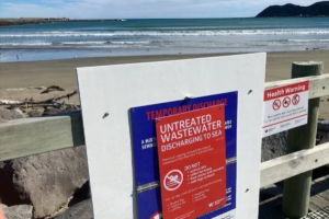 Temporary untreated wastewater discharge warning sign on Wellington’s South Coast beach following the Moa Point wastewater treatment plant failure.