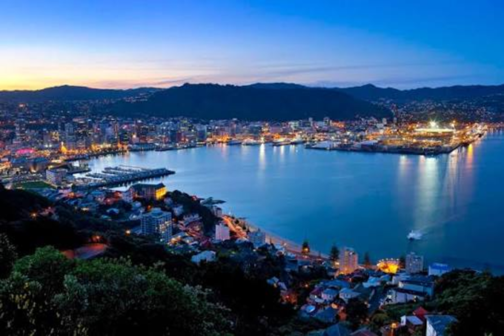 Wellington city and harbour at dusk, viewed from the hills above the central city.