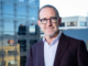 Wellington Mayor Andrew Little standing outside a modern office building.