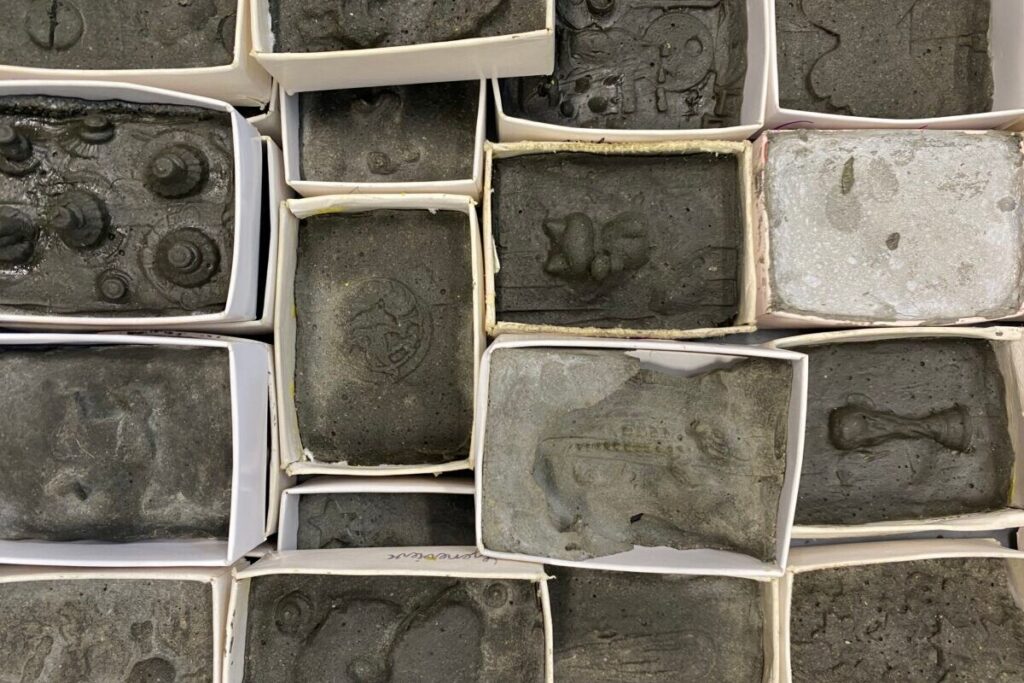 Small sculptures by Te Aro School children arranged inside white matchboxes.